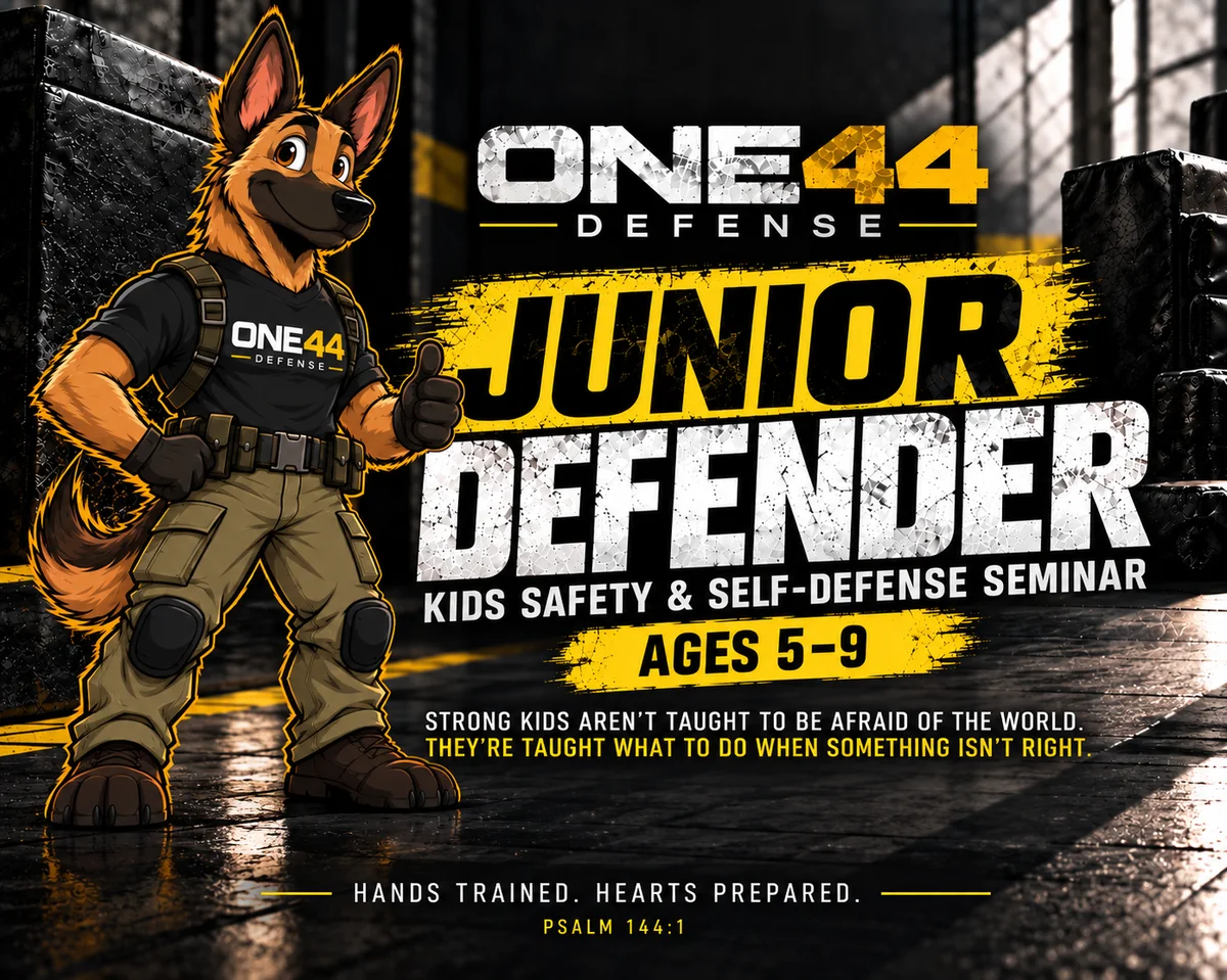 ONE44 Defense Junior Defender — Kids Safety & Self-Defense Seminar, ages 5 to 9. A cartoon German Shepherd in ONE44 Defense training gear gives a thumbs up. Strong kids aren't taught to be afraid of the world; they're taught what to do when something isn't right. Hands trained. Hearts prepared. Psalm 144:1.