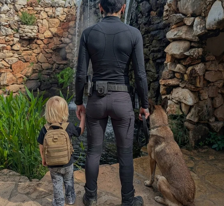 Alicia Mills walking with a child and a working K9 at heel
