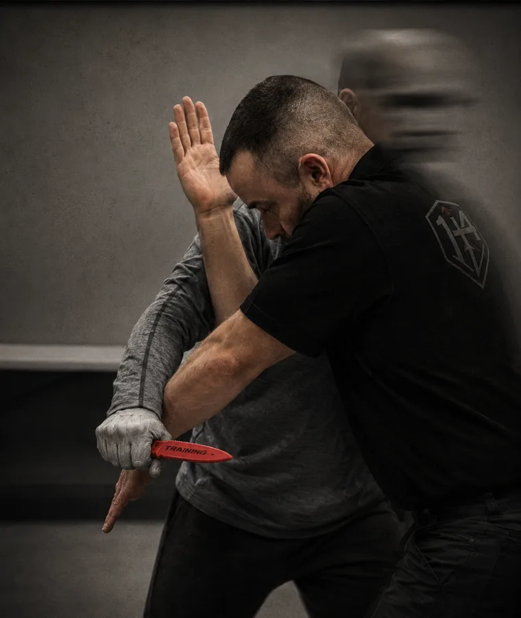 Edged weapon defense — controlling the knife arm with a training blade